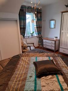 a bedroom with a large bed with a pillow on it at Aux Volets Bleus in Sibiril