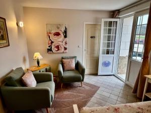 a living room with two chairs and a couch at Sans Souci Bed and Breakfast Luxe Heated Pool and Restaurant in Luzillé