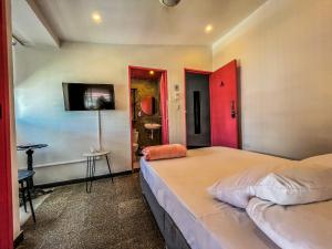 Postel nebo postele na pokoji v ubytování Fardo Hotel Boutique en Ibague - Zona G - Recepción Digital 24H