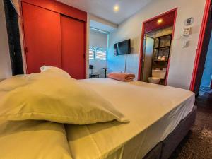 Postel nebo postele na pokoji v ubytování Fardo Hotel Boutique en Ibague - Zona G - Recepción Digital 24H