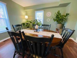 a dining room with a wooden table and chairs at Charming cottage in the heart of Wellington in Wellington