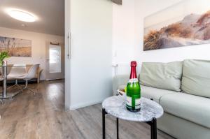 a bottle of wine on a table in a living room at Abendmond in Zinnowitz