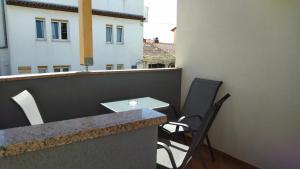 a balcony with a table and chairs on a roof at Apartment Uki in Premantura