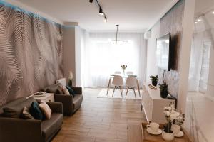 a living room with a couch and a table at Apartament Rozmarynowa Residence 8 Opole in Opole