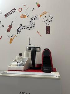 a toaster sitting on a shelf with musical notes at La Lirica rooms in Verona +35 photos