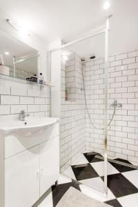 a white bathroom with a sink and a shower at 57 Steps from the Basilica in Budapest