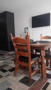 a wooden dining room table with two chairs and a table at Apartament Włoski Styl in Gniezno