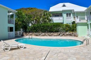 a swimming pool in front of a house at Vive Les Vacances in Cul de Sac