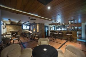 a bar in a restaurant with chairs and a table at Hotel Sun Loznica in Loznica