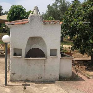 an outdoor pizza oven with anubisificialificialificialificialificialificialificialificialificial at Villa Despina in Saint Minas