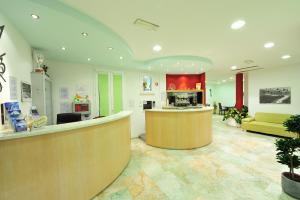a lobby with a waiting area and a reception desk at Hotel Aurora in San Vincenzo