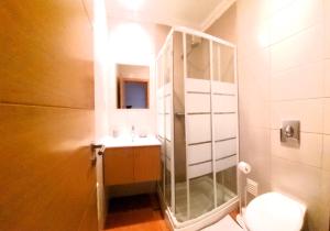 a bathroom with a sink and a toilet with a mirror at Ocean & Nature Flat - Aljezur - Algarve West Coast - 1,6km Praia Monte Clérigo in Aljezur +30 photos