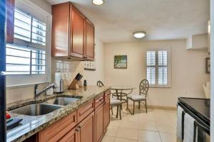 a large kitchen with a sink and a table at Summer Sands Lodge in Flagler Beach