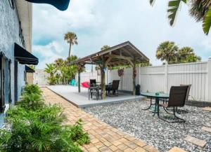 a patio with a gazebo and a table at Summer Sands Lodge in Flagler Beach
