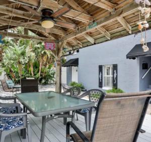 a patio with a table and chairs on a deck at Summer Sands Lodge in Flagler Beach