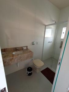 a bathroom with a toilet and a sink and a shower at Hotel Mafra in Mafra
