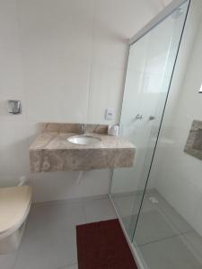 a bathroom with a sink and a shower at Hotel Mafra in Mafra