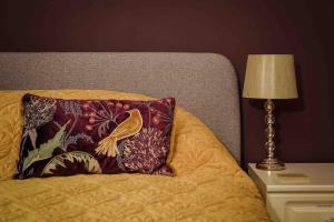 una almohada sentada en una cama junto a una lámpara en Southdene Studio en Lincoln