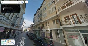 a city street with cars parked in front of buildings at Eva apartment in Ohrid