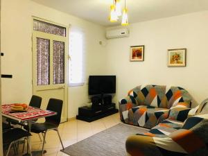 a living room with a couch and a table at SALA Apartments in Velipojë