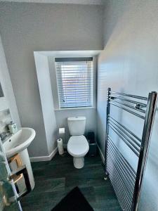 a bathroom with a toilet and a sink at Argyle House Wick in Wick