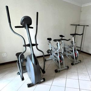 two exercise bikes are parked in a room at La Place 56 in Pretoria