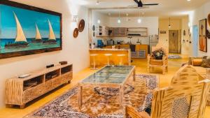 a living room with a large tv on the wall at Casa Maridadi in Watamu