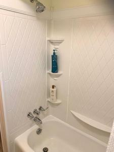 a bathroom with a sink and a bath tub at The House Hotels - Erie Street 1 in Cuyahoga Falls