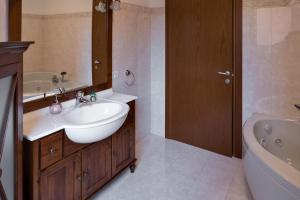 a bathroom with a sink and a toilet and a tub at LA VELA in Negrar +5 photos