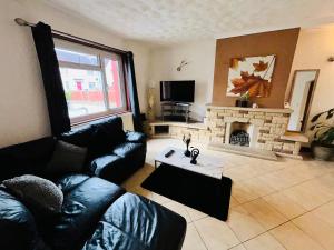 a living room with a couch and a fireplace at The European 3 Bedroom House By AltoLuxoExperience Short Lets & Serviced Accommodation With Free Parking in Bristol