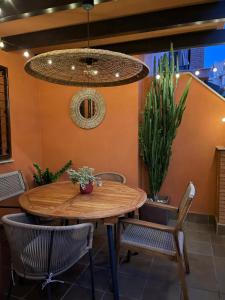 a dining room with a wooden table and chairs at La casa de Mateo Playa Granada in Motril
