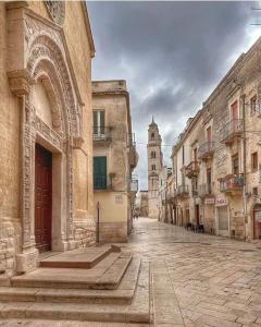 an empty street in an old town with buildings at Martinirooms in Altamura