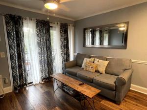 a living room with a couch and a table at Crashin' Waves-Oceanview Bikes and King Bed in Hilton Head Island