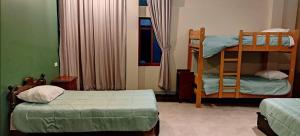 a bedroom with two bunk beds and a bed at Guest house. Shared room in panoramic apartment. Private bathroom. Kitchen and washmachine in Huaraz +4 photos