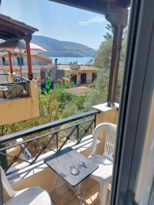a balcony with a table and chairs and a view at Marilena Rooms Plataria in Plataria
