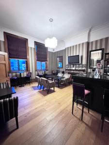 a large room with chairs and tables and windows at Cathedral Quarter Hotel - Derby in Derby