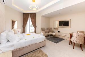 a hotel room with a large bed and a television at Marom Port Said Resort in Port Said