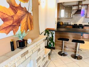 a kitchen with a counter and two stools at The Portuguese 3 Bedroom House & Studio By AltoLuxoExperience Short Lets & Serviced Accommodation With Free Parking in Bristol