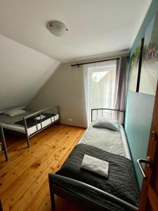 a bedroom with two bunk beds and a window at Wigierska Osada in Danowskie