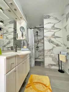 a bathroom with a shower and a sink and a mirror at Apartments Hajl in Krk