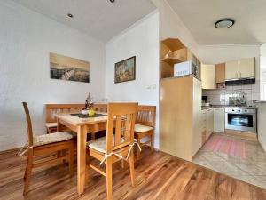 a kitchen and dining room with a table and chairs at Apartments Hajl in Krk