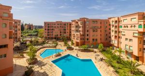 an aerial view of an apartment complex with two swimming pools at Charming 2-Bed Oasis Pool View in Marrakesh