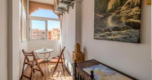 a room with a table and a window and a table at Charming 2-Bed Oasis Pool View in Marrakech