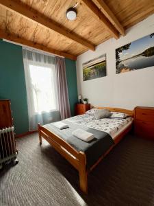 a bedroom with a bed and a large window at Wigierska Osada 2 in Danowskie