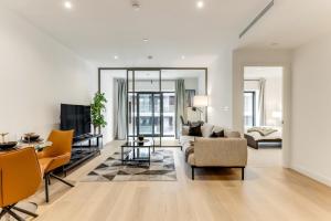 a living room with a couch and a table at Khayat Homes - The Ostrich - One Bed Luxury Apt in London