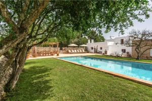 a swimming pool in front of a house at CAN FERRER Authentic payesa house in San Antonio