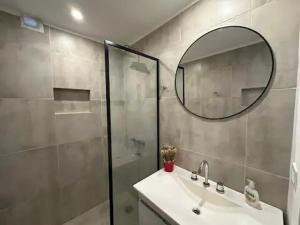 a bathroom with a shower and a sink and a mirror at La Plaza Lobos Apartment in Lobos +11 photos