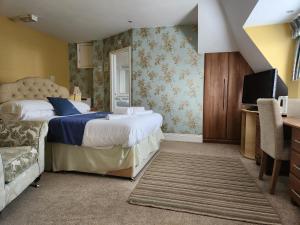 a hotel room with two beds and a television at The Mayfair guest house self catering in Southampton