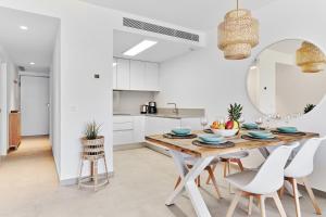 a kitchen and dining room with a table and chairs at Playa Carabassi Sea View Apartment in Gran Alacant, Large Terrace in Gran Alacant