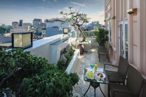 a balcony with a table and a view of a city at The Light Hotel in Hanoi
